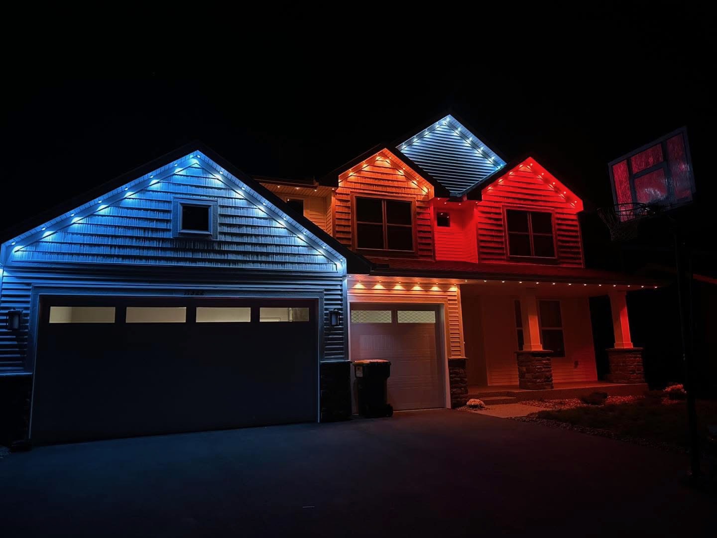Red, white and blue permanent LED lighting on a stucco home